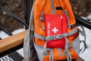 A backpack that contains a comprehensive first aid kit for emergencies, ensuring preparedness for various situations while on the go, perfect for outdoor adventures or daily use photo
