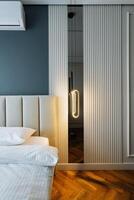 The room in question is a bedroom that contains a comfortable bed and features a sliding glass door that opens up to an outdoor space, enhancing the rooms appeal and functionality photo
