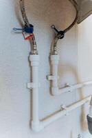 This image presents a meticulously captured closeup view of a white pipe that has a hose firmly attached to it, showcasing the vital and essential connection between these two components photo