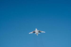 There is an aircraft, specifically a plane, navigating through the vast, clear expanse of the blue sky during daylight hours, showcasing the beauty of air travel in aviation photo