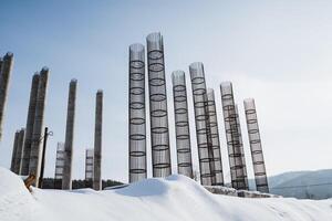 A row of ice sculptures in the snow with a blue sky in the background photo