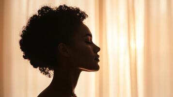 Contemplative woman silhouette soft draped background portrait tranquil environment side view inner peace concept photo