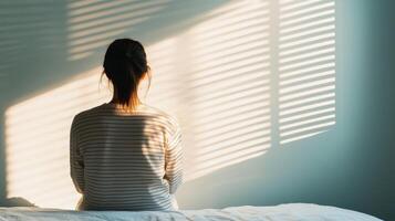 Reflective moment indoor bedroom personal portrait serene background soft light contemplative viewpoint photo