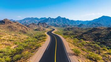 Winding scenic road through desert mountains landscape aerial view nature background photo
