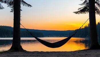 Relaxing hammock at sunset by tranquil lake nature background serene landscape peaceful environment photo