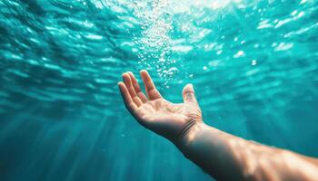 Action of a Swimmer's Hand Reaching into Clear Water Underwater Scene Background with Copyspace photo