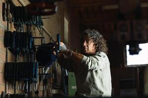 Man using carpentry tool in workshop photo