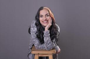 Beautiful woman looking at camera with hands on face. photo