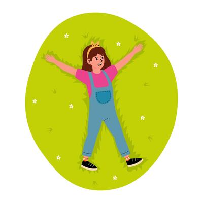 Child enjoying a sunny day making snow angels on green grass in a park