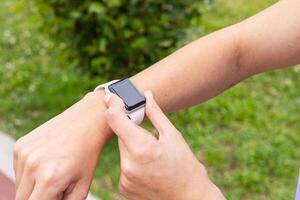 A person is holding an apple watch on their wrist photo