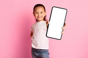 I Like It. Happy asian girl showing thumbs up and widely smiling, isolated over pastel pink studio wall, copyspace photo