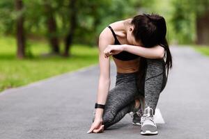 Exhausted Asian Jogger Girl Resting On Path In Park After Long Run, Taking Breath And Relaxing, Copy Space photo