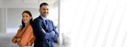 Two professionals stand confidently back to back in a bright office space, showcasing teamwork and cooperation. They represent success and dedication in the corporate world, copy space photo