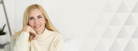 Portrait Of Mature Woman Smiling At Camera, Resting At Home, Copy Space photo