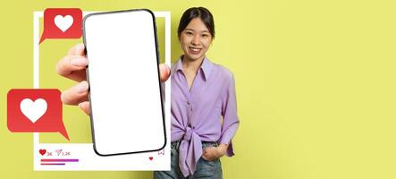 An influencer stands against a bright yellow background, holding a smartphone with a blank screen, highlighting social media interaction through likes and messages. The setting is lively and modern. photo