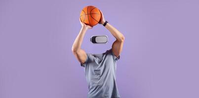 A person wearing a virtual reality headset is jumping to shoot a basketball, with their head absent. The background is a vibrant purple, emphasizing the action and technology. photo