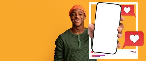 A young influencer smiles while holding a smartphone, showcasing a blank screen. Colorful chat bubbles with heart icons indicate active social media interaction and connection with followers. photo