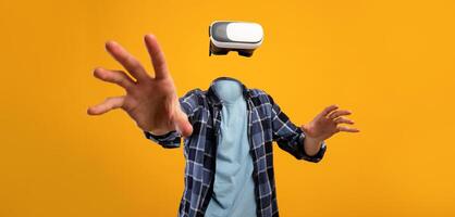 A person engages with a virtual reality headset in a lively setting. Their head is absent, emphasizing the modern gadget. The bright background enhances the immersive experience of technology. photo