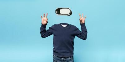 A person is interacting with a virtual reality gadget, wearing headset-style goggles. They are posing with hands raised, creating an intriguing visual of modern technology without a visible head. photo