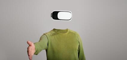 A user wearing a modern virtual reality headset, with no visible head or face, reaches out as if inviting interaction. The minimalist background emphasizes the advanced gadget's features. photo
