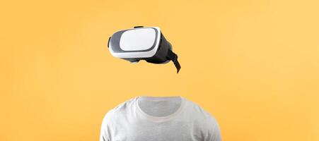 A user utilizes a virtual reality headset with no visible head or face against a bright yellow background. This setup highlights cutting-edge technology for immersive experiences. photo