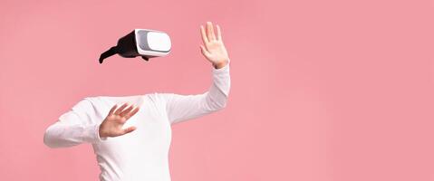 A user engages with a virtual reality headset, fully immersed in a tech-driven experience. The scene is devoid of facial features, emphasizing the gadget's modern appeal. photo