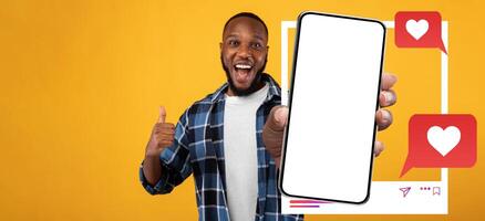 An influencer enthusiastically presents a smartphone, displaying his excitement about social media interactions. The background is bright and inviting, highlighting the device and empty screen. photo