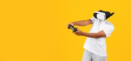 A person participates in a virtual reality activity, wearing a modern headset while holding a game controller. The background is bright yellow, enhancing the immersive experience. photo
