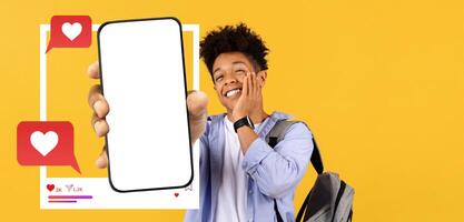 An influencer holds out a smartphone displaying an empty screen while smiling enthusiastically. photo