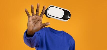 A person is interacting with a virtual reality gadget, wearing goggles without visible facial features. The vibrant background adds a dynamic feel to this technology-focused moment. photo