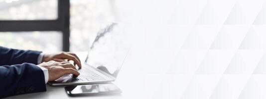 Closeup Shot Of Hands Of Unrecognizable Businessman In Suit Working On Laptop While Sitting At Desk In Office, Man Entrepreneur Typing On Computer Keyboard At Workplace, Side View Shot, Cropped photo