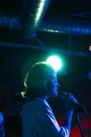 Musicians In Stage With Colorful Lights Performing In A Live Concert photo