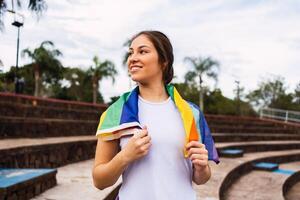Smiling ethnic sportswoman with a towel outdoors on sunny day photo