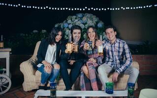 Happy friends drinking and having fun in a party photo