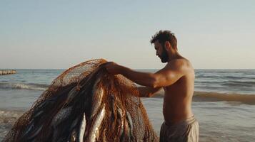 Fisherman unloads a net full of fish on a sandy beach at sunset photo