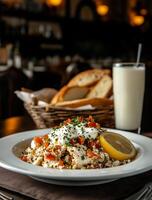 Delicious savory dish with yogurt sauce, vegetables, and lemon photo
