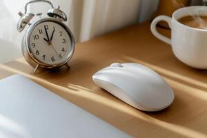 Cozy workspace with clock, mouse, and coffee photo