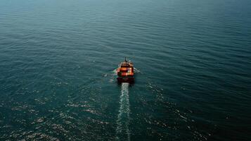 An aerial view of a boat traveling across the ocean photo