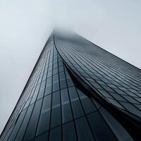 Modern skyscraper, shrouded in mist. Dynamic architectural facade photo