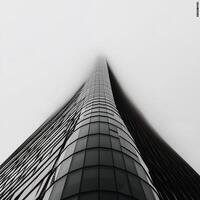 Modern skyscraper pierces misty sky photo