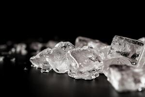 Close-up of ice cubes on a dark surface photo