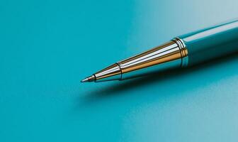 Close-up of a pen tip on a vibrant blue surface. Detailed view of the pen's metal components photo