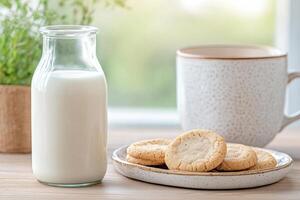 Homemade sugar cookies and cold fresh milk sit next to a window ready for a warm, comforting morning breakfast in a bright and rustic kitchen photo