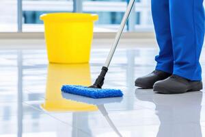 Janitorial worker meticulously mopping glossy floor to achieve a streak-free shine in a clean environment photo