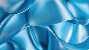 Wavy blue ribbons float gracefully in a surreal setting with soft lighting and a satin texture, creating an artistic atmosphere photo