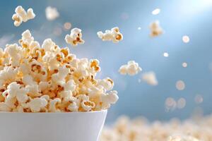 Bowl Overflowing with Freshly Popped Popcorn Exploding on a Blue Background photo