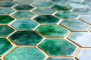 Emerald green hexagonal tiles creating a textured honeycomb pattern photo