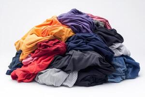 Pile of colorful crumpled clothes forming a small mountain on white background photo