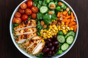 Sliced grilled chicken breast and quinoa with colorful vegetables making a healthy and balanced meal photo