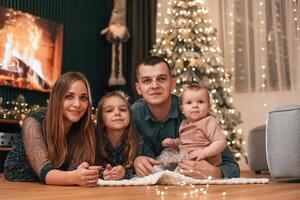 Happy, family is sitting together at home. Celebrating New Year photo